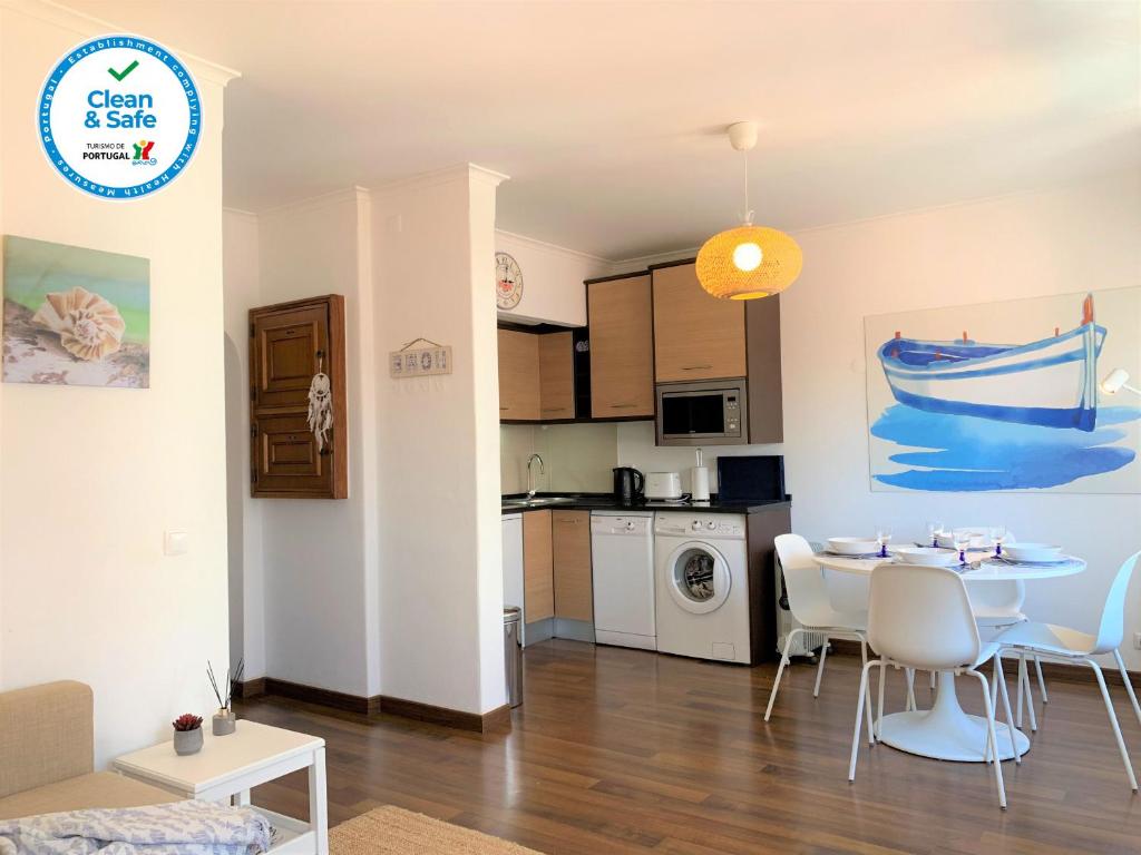 a kitchen and living room with a table and chairs at Relaxing apartment in the heart of Cascais in Cascais