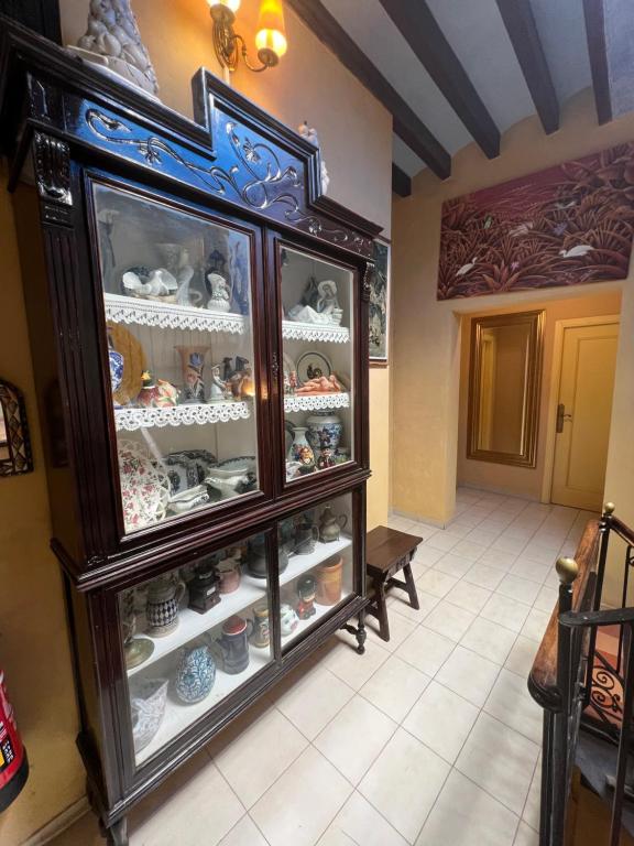 a display cabinet filled with lots of dishes at La Ventana in Ibiza Town