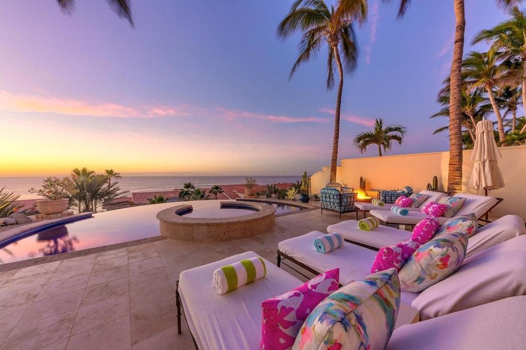 a pool with chaise lounges next to the ocean at Luxurious 5bd Del Mar Palmilla Villa Staffed and Swimmable Beach in San José del Cabo