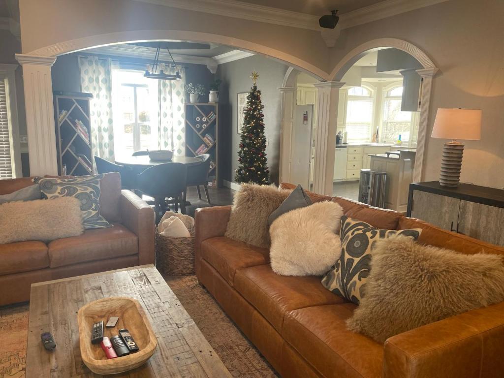 a living room with a couch and a christmas tree at Bentonville Biking and Business in Bentonville