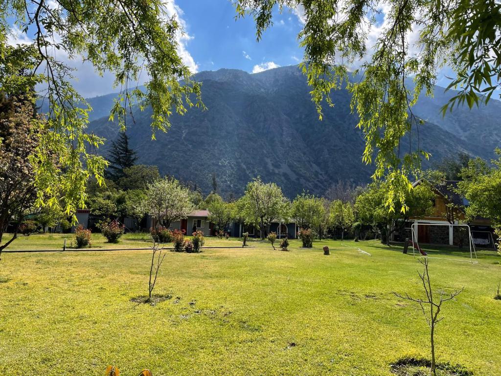 a park with a mountain in the background at Campito Refugio in San José de Maipo
