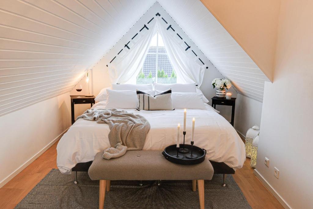 a bedroom with a large bed with a window at Fully Equipped Home Close to Malmö & Copenhagen in Vellinge