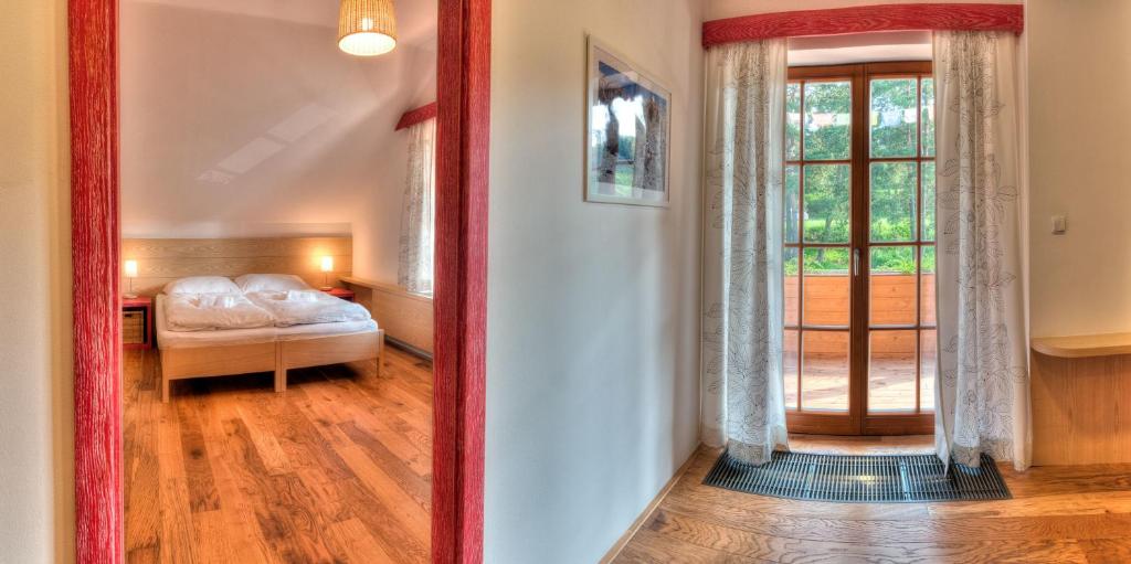 a mirror reflecting a bedroom with a bed and a window at Statek Samsara in Blansko