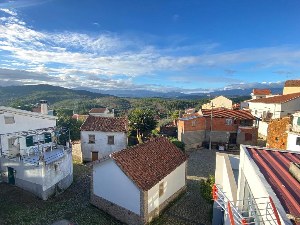 a view of a small town with houses and mountains at Casa do Adro in Lavacolhos