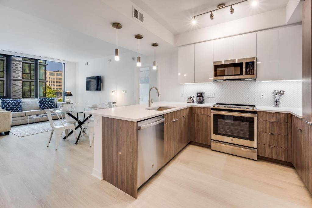 a kitchen with white walls and wooden cabinets at Global Luxury Suites at Capitol Hill in Washington