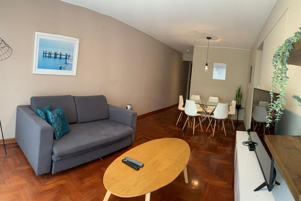 a living room with a couch and a table at MLA apartments - Kennedy in Lima