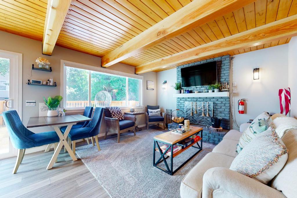 a living room with a couch and a table at Hemlock Haven in Lake Arrowhead