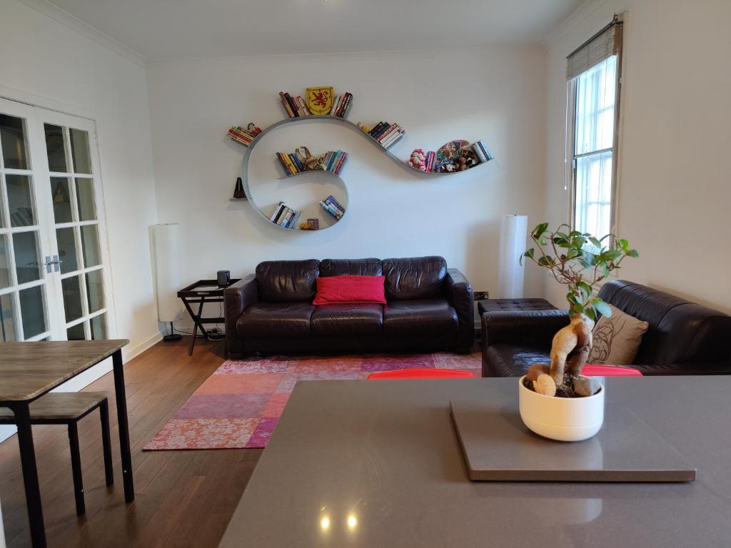 a living room with a couch and a table at University and Central Edinburgh in Edinburgh