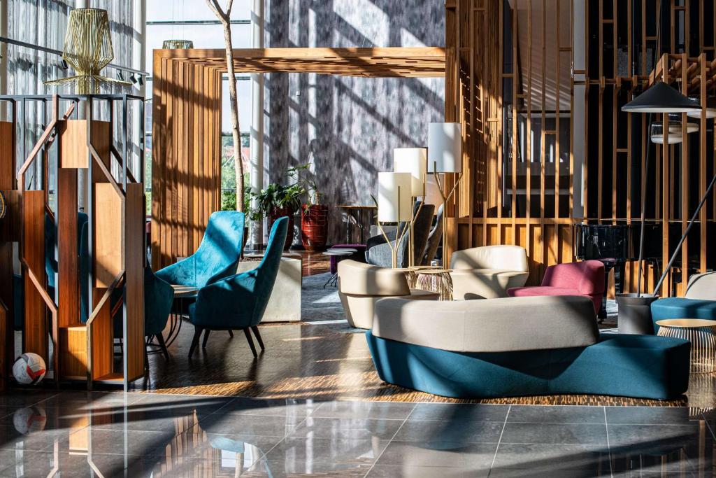 un vestíbulo con mesas y sillas coloridas en Radisson Blu Hotel Lietuva en Vilna