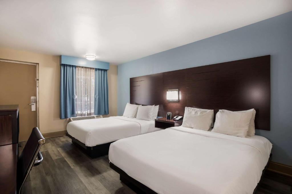 a hotel room with two beds and a window at SureStay Hotel by Best Western Bardstown General Nelson in Bardstown