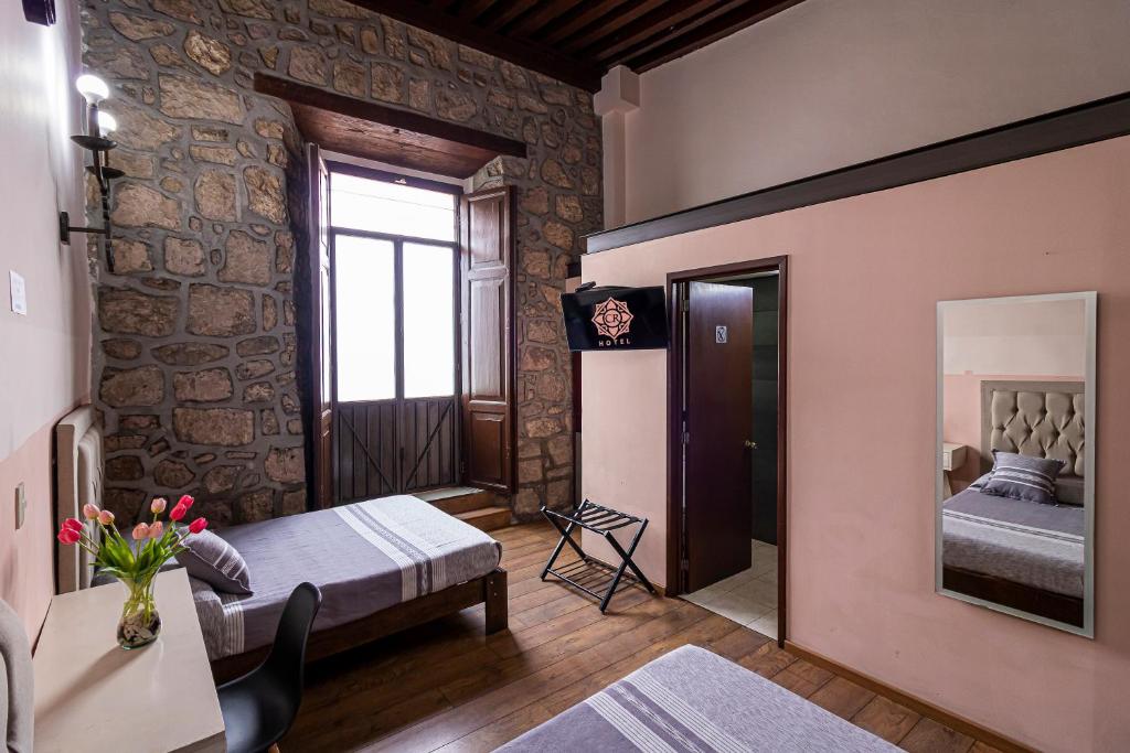 Postel nebo postele na pokoji v ubytování Hotel Cantera Rosa