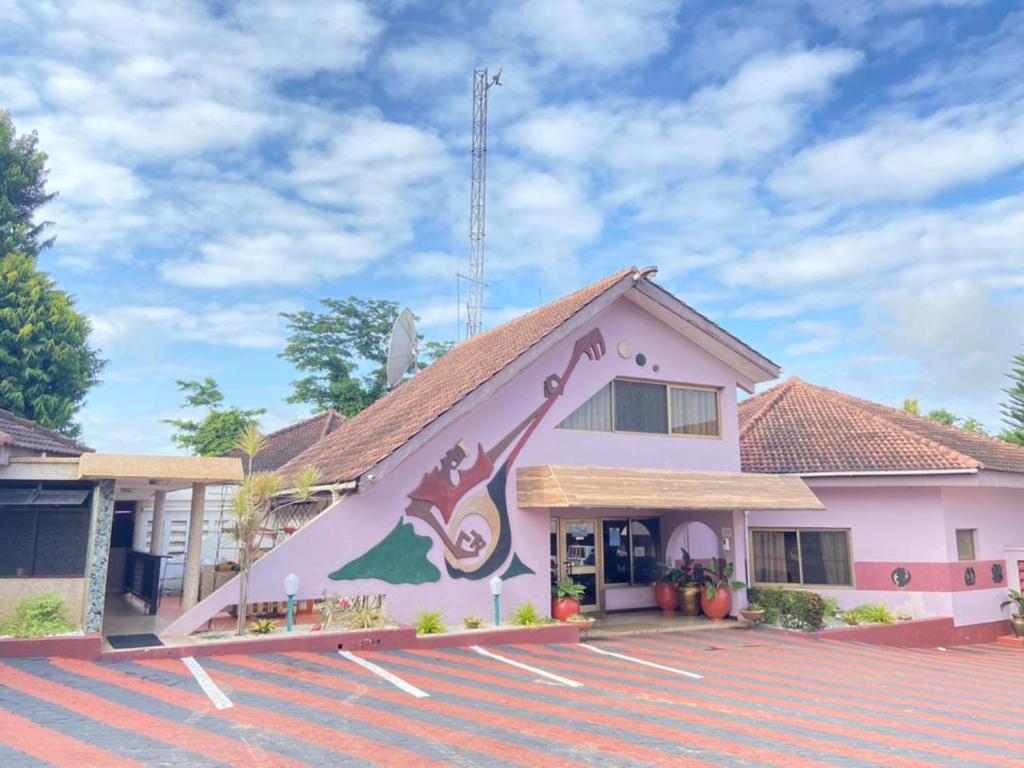 un edificio con un mural en el costado en ROYAL BASIN RESORT en Kumasi