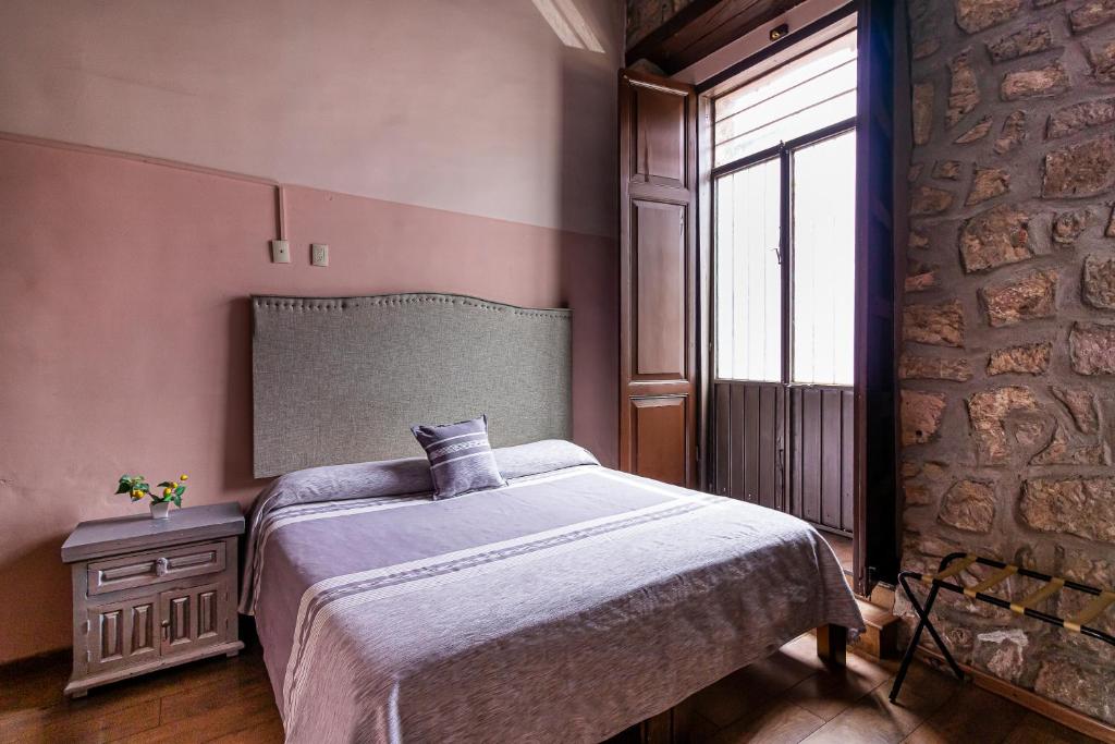 Postel nebo postele na pokoji v ubytování Hotel Cantera Rosa