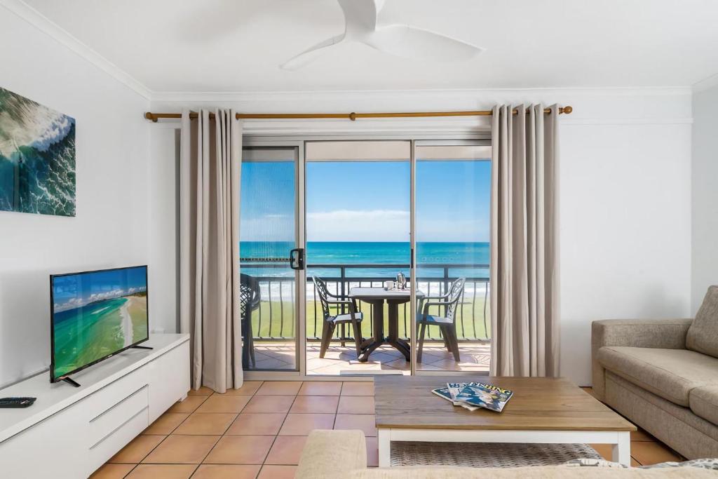 a living room with a view of the ocean at Apartment 8T in Lennox Head