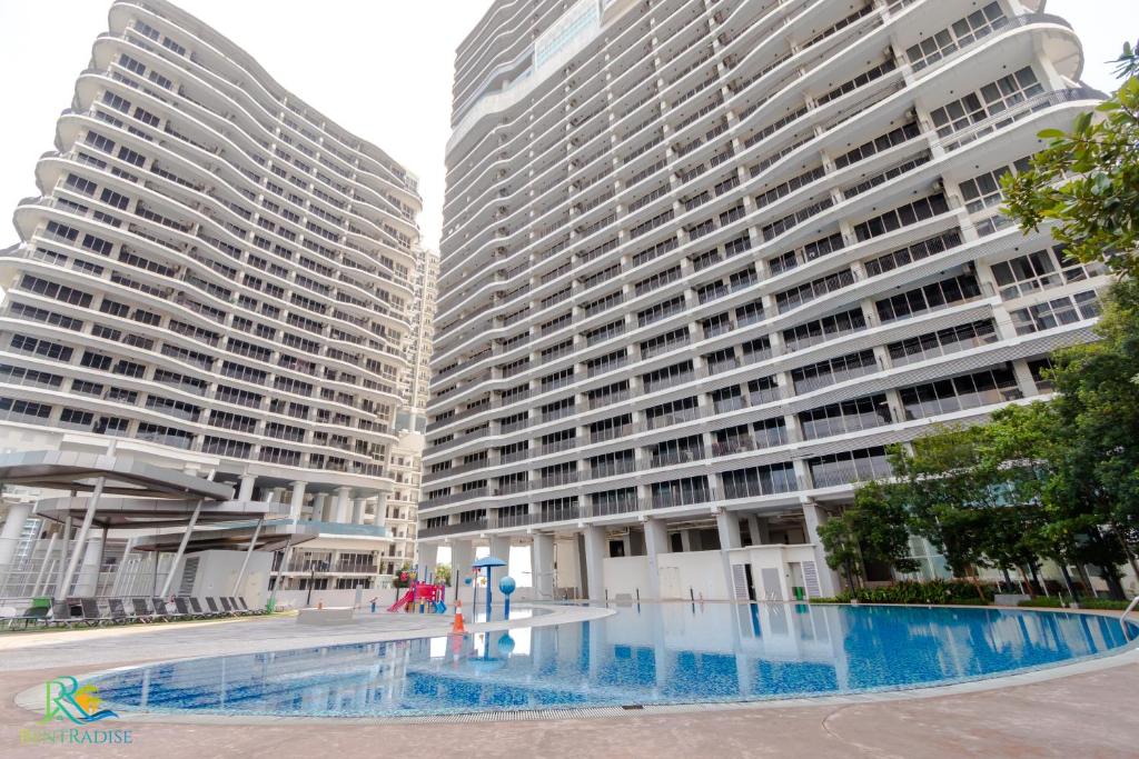 two tall buildings with a pool in front of them at Encorp Marina Puteri Harbour by RR JBcity in Nusajaya