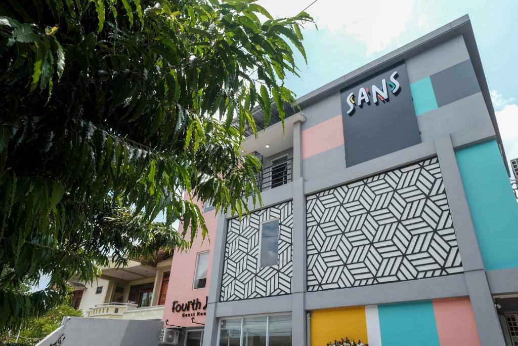 a building with a santas sign on it at Sans Hotel Fourth Loft Solo in Solo