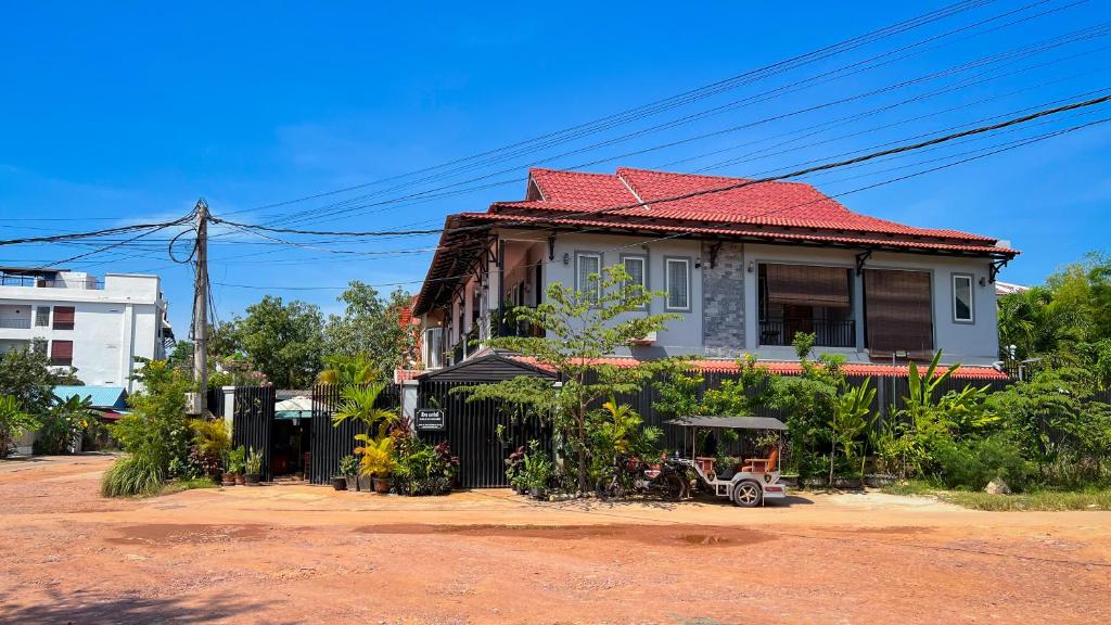 a house with a tractor parked in front of it at Nika's House in Siem Reap