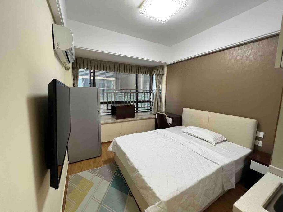 מיטה או מיטות בחדר ב-金边市中央广场高层24平米小单间20美金每天