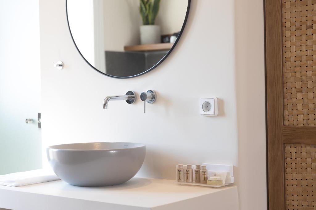 a bathroom with a bowl sink and a mirror at Almi of Naxos in Naxos Chora