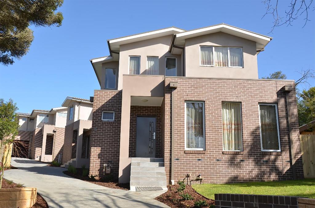a large brick house with a driveway at Melbourne Luxury Villa at Doncaster in Nunawading