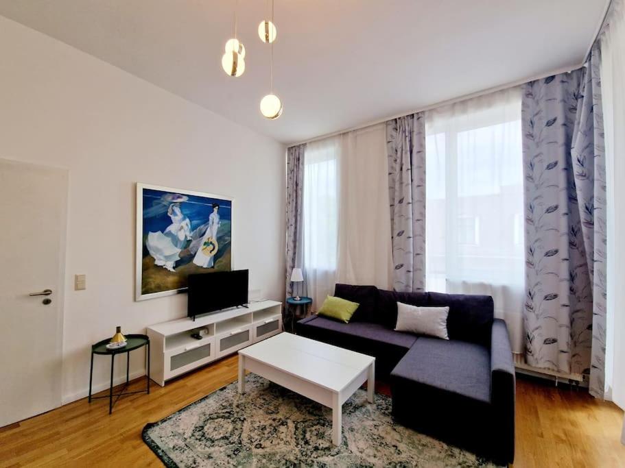 a living room with a couch and a table at Luxury apartament in the heart of Berlin 45 in Berlin