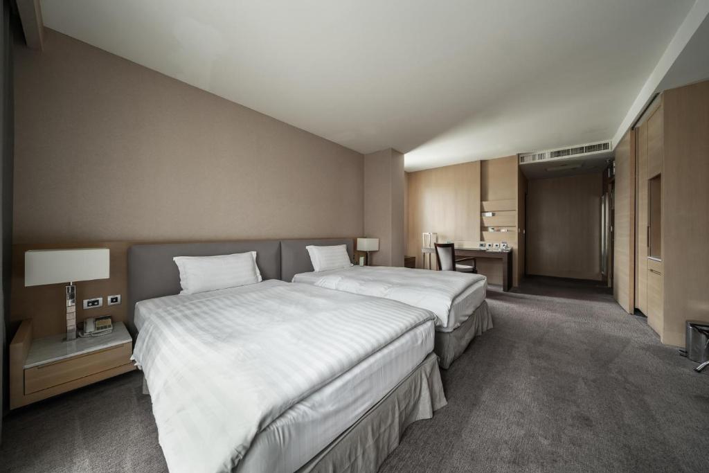 Postel nebo postele na pokoji v ubytování Taipung Suites