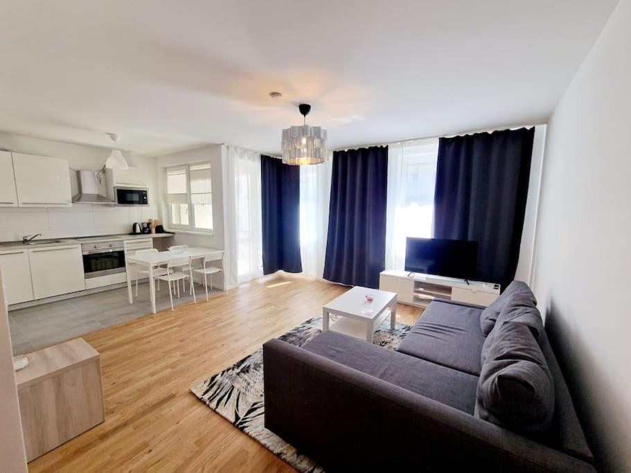 a living room with a couch and a kitchen at Luxurious studio in the center of Berlin 31 in Berlin