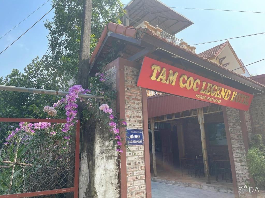 a restaurant with a sign on the side of a building at Tam Coc Legend Hotel in Ninh Binh