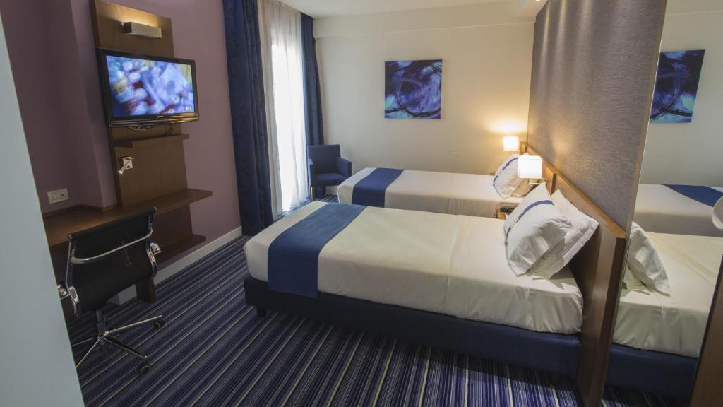 Posteľ alebo postele v izbe v ubytovaní GP Hotel