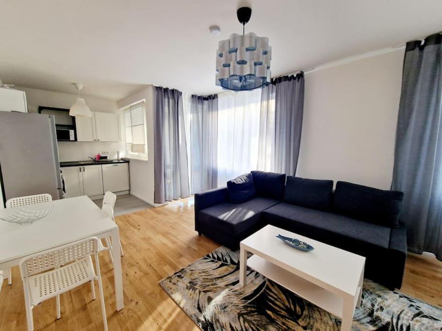 a living room with a blue couch and a table at Nice apartment in the heart of Berlin 13 in Berlin