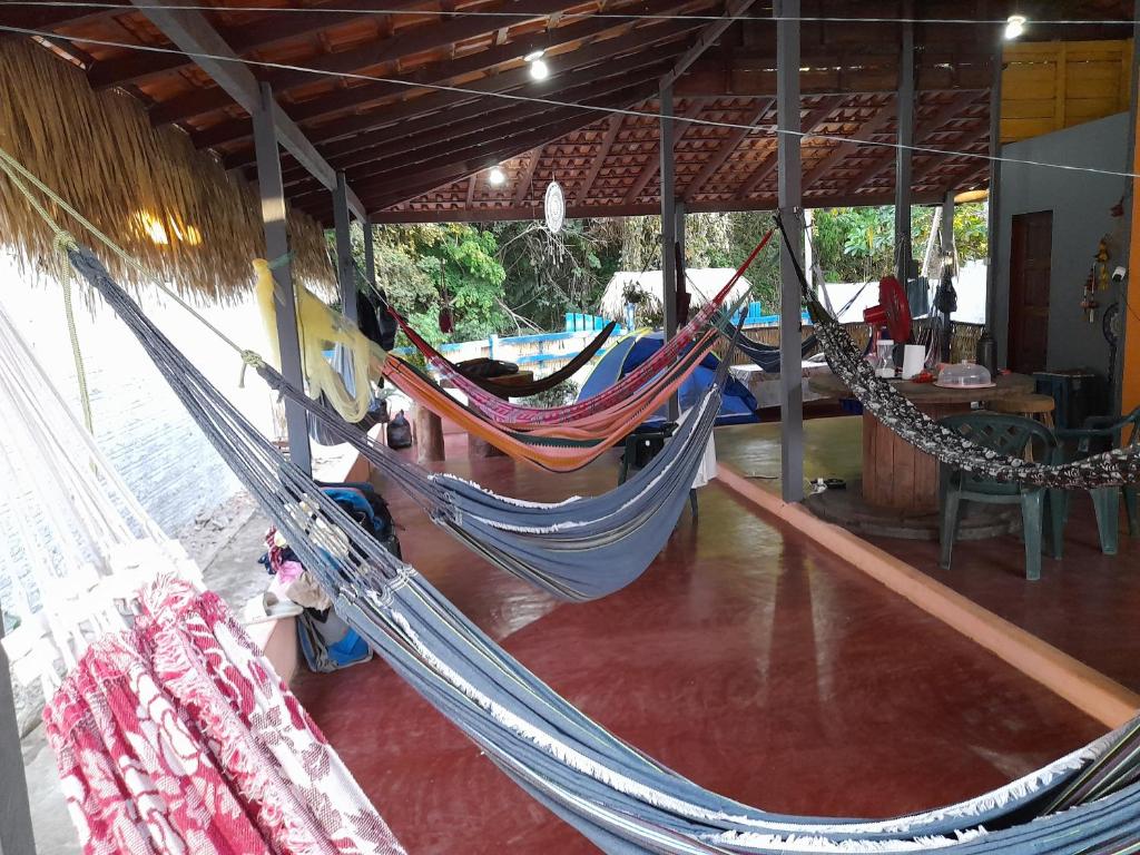 a group of hammocks hanging from a building at Redario BOTOS DE ALTER in Alter do Chao