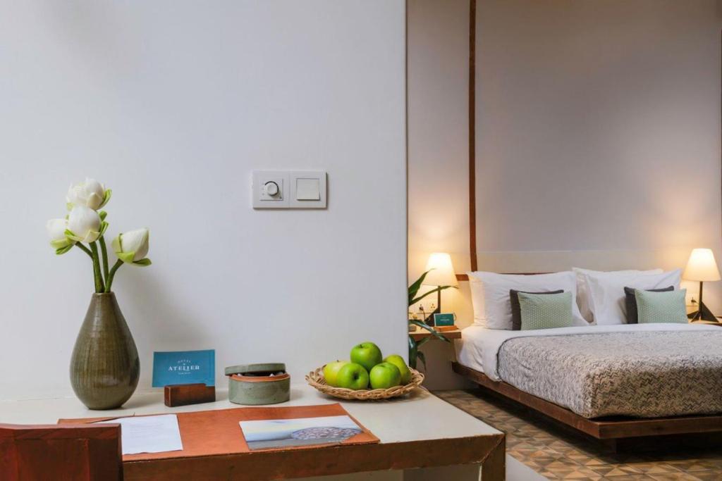 Postel nebo postele na pokoji v ubytování Atelier Hotel