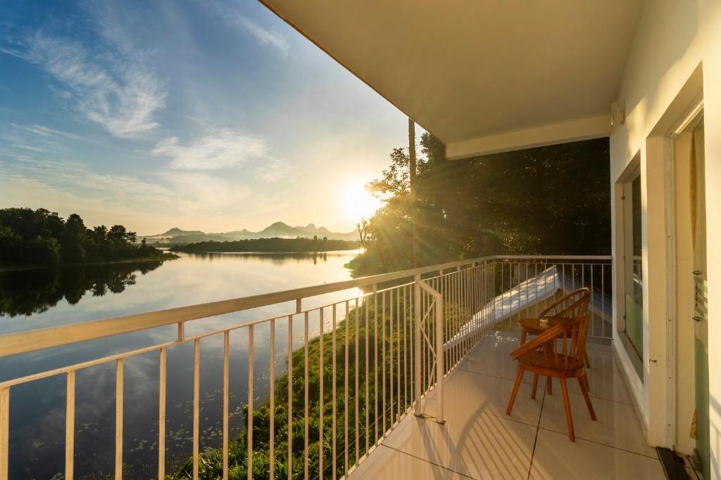 a balcony with a view of a river at Karapuzha Village Resort in Wayanad