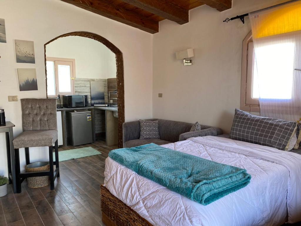 a bedroom with a bed and a couch and a kitchen at Mazarita Beach Residence in Sharm El Sheikh