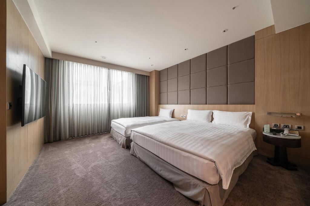 Postel nebo postele na pokoji v ubytování Taipung Suites
