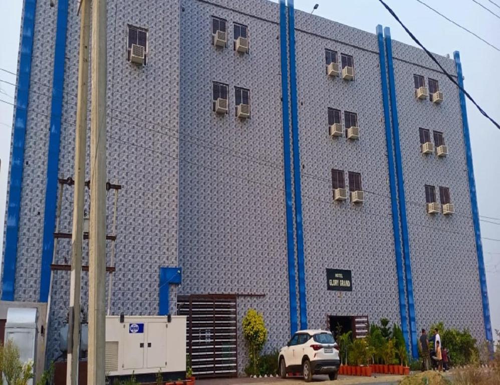 a large building with blue scaffolding on it at Hotel Glory Grand, Rajgir in Rājgīr