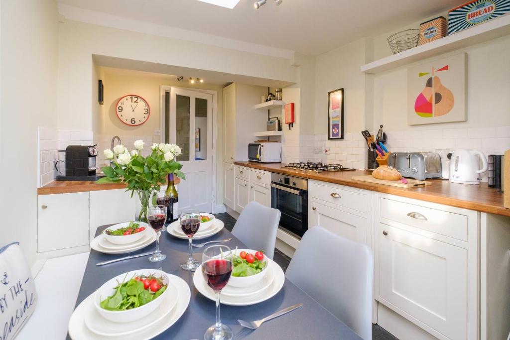 a kitchen with a table with two plates of food at Sleepers Cottage in Aldeburgh