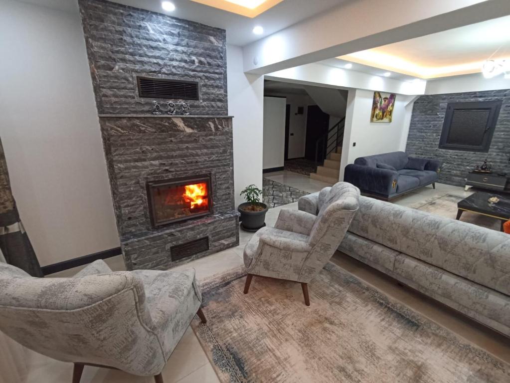 sala de estar con sofá y chimenea en Villa KayaHan Göcek en Göcek