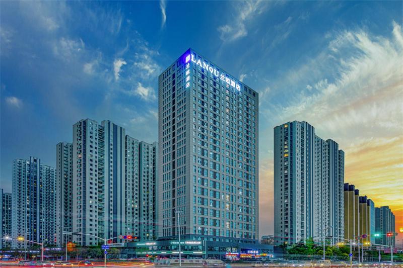 a tall building with a purple light on top of it at LanOu Hotel Linyi Lanshan Lushang Center Wanda Plaza in Linyi
