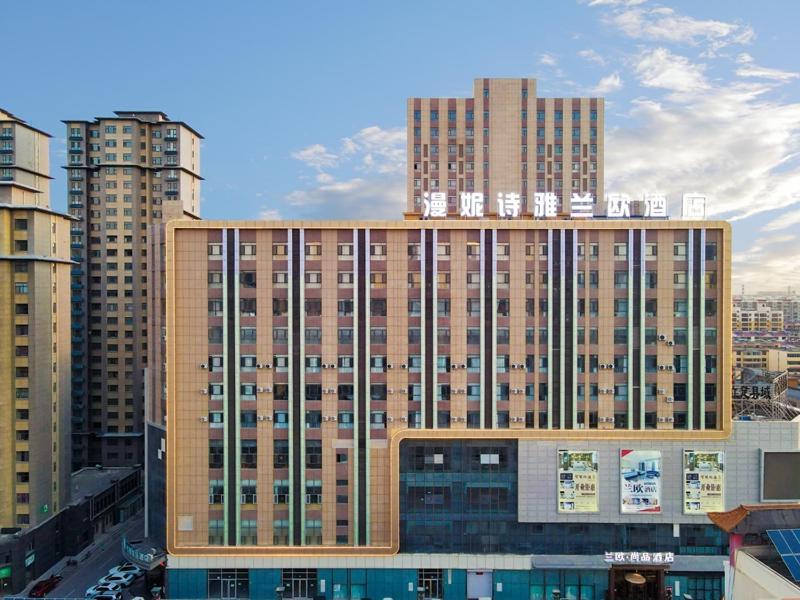 a large building in a city with tall buildings at LanOu Hotel Zhongning Weimin City Plaza in Jiangoushan