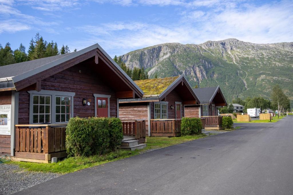a row of houses in front of a mountain at Topcamp Mosjøen - Helgeland in Mosjøen