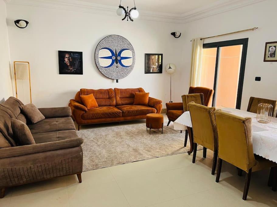a living room with a couch and a table at TérangaLux Appartement Le Yoruba Dakar Sacré Cœur 3 in Dakar