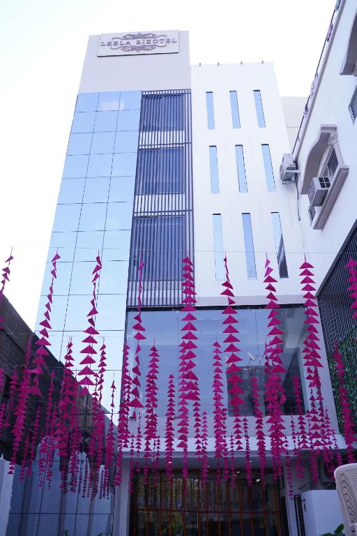 a building with a bunch of pink streamers in front of it at LEELA BIZOTEL in Junagadh