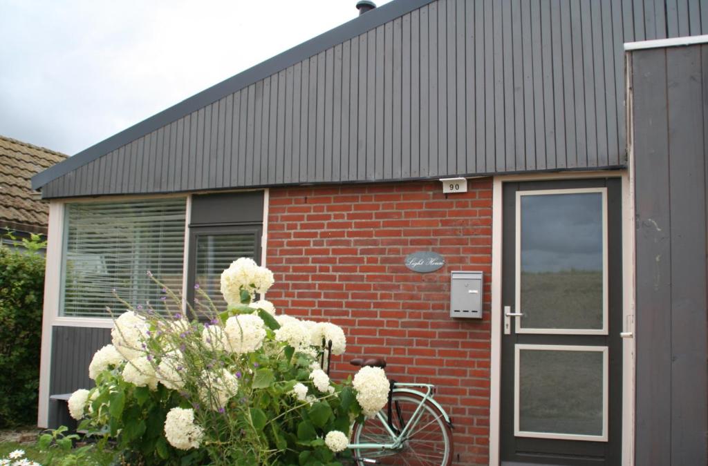 una bicicleta estacionada frente a un edificio de ladrillo en Rekerlanden 90 en Schoorldam