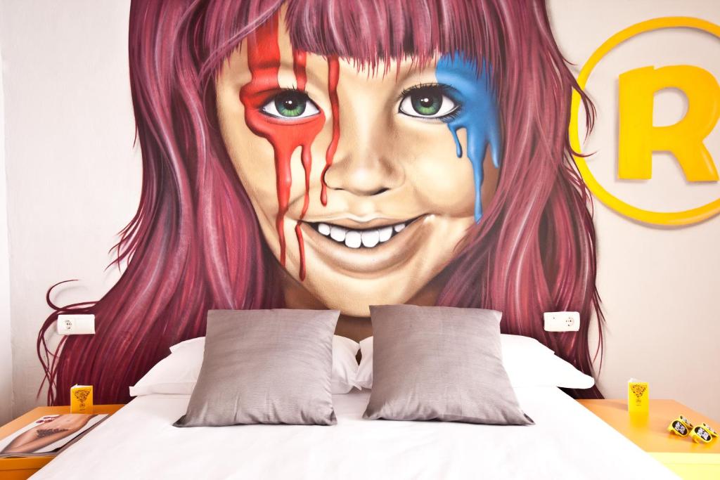 a mural of a girl with pink hair at Ryans Budget in Ibiza Town