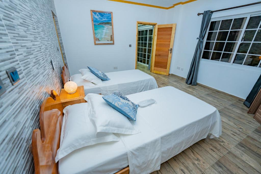 Postel nebo postele na pokoji v ubytování Paradise Breeze Apartment