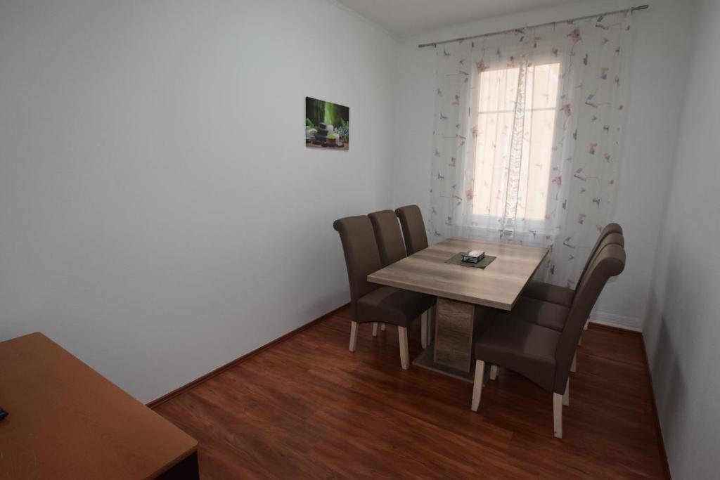 a small dining room with a table and chairs at Wasen Apartment in Stuttgart