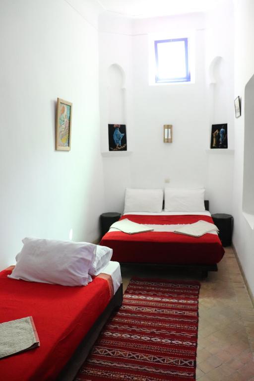 Postel nebo postele na pokoji v ubytování Hotel Dar El Qdima