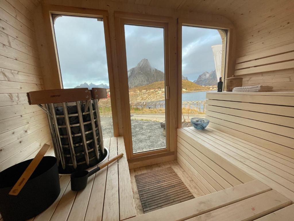 a sauna with a view of the mountains at Catogården - Boutique Home & Activity Centre in Reine