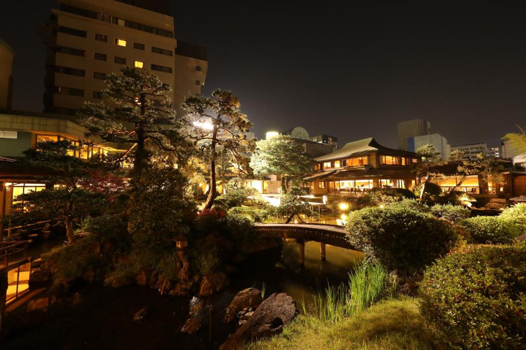 un puente sobre un río en una ciudad por la noche en Art Hotel Kokura New Tagawa, en Kitakyushu